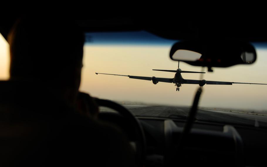 An Air Force airman drives behind a U-2 Dragon Lady while it lands at an undisclosed location in Southwest Asia in this Nov. 2010 photo.  The U-2 needs a chase vehicle to communicate altitude and alignment corrections when landing. 