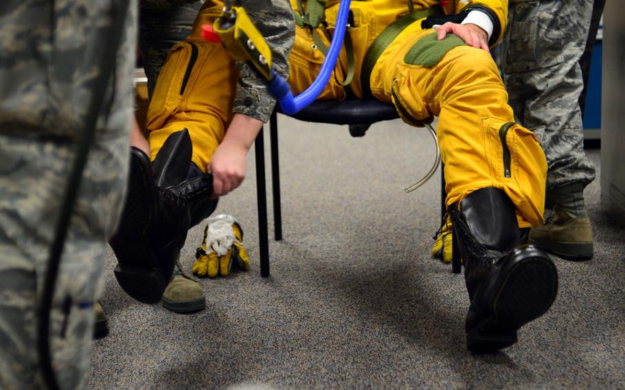 Staff Sgt. Heather Doyle, 9th Physiological Support Squadron launch and recovery technician, fits a specialized boot to U-2 pilot Capt. Travis, in preparation for a "high flight" at Beale Air Force Base, Calif., Jan. 8, 2013. Since its inception in 1955, the U-2 has required the use of a pressure suit to regulate the pressure for pilots above 50,000 feet. The U-2 is the only aircraft in the Department of Defense inventory that requires the utilization of a full pressure suit.