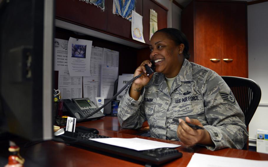 Air Force Staff Sgt. Nikia Youman, noncommissioned officer in charge of Formal Training, talks with a customer on March 13, 2013 at Ramstein Air Base, Germany. Youman is one of many servicemembers affected by the recently suspended tuition assistance program. Her family can't afford to pay for her education outright and she'd like to leave what remains of her GI Bill benefits to her children.