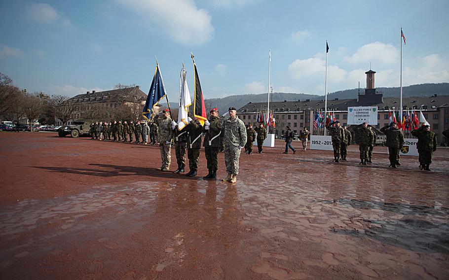 A color guard for NATO's Headquarters Allied Force Command Heidelberg steps forward for a casing of the colors ceremony Thursday at Campbell Barracks in Heidelberg, Germany.