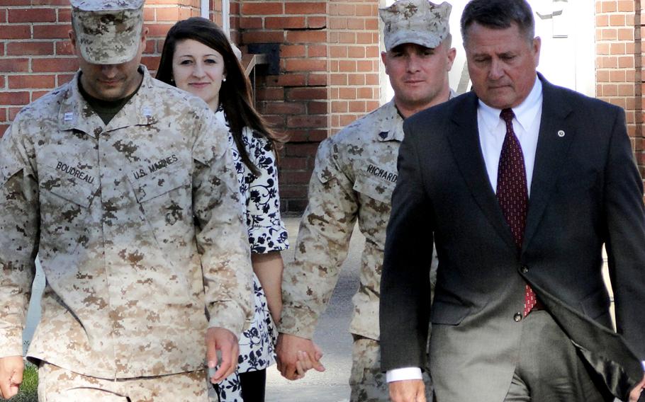 Military defense counsel Capt. Robert Boudreau, Raechel Richards, Sgt. Robert Richards and defense lawyer Guy Womack leave the courtroom at Camp Lejeune, N.C., on March 19, 2013.
