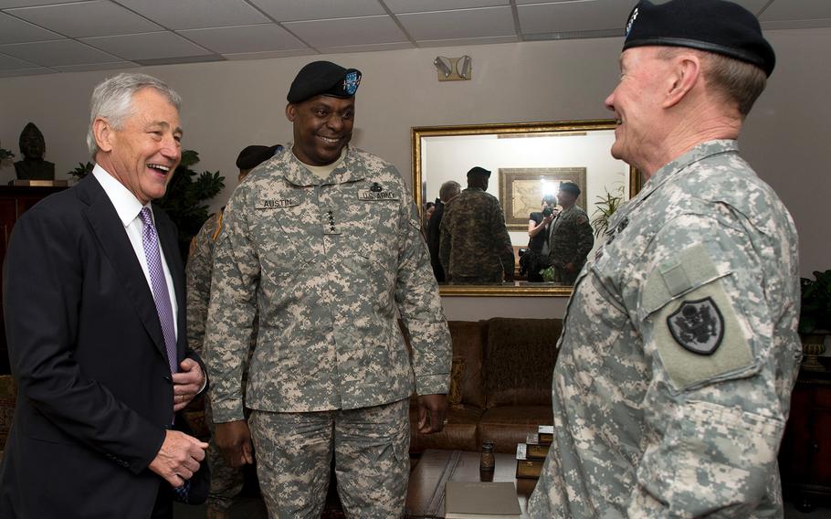 Secretary of Defense Chuck Hagel laughs with Gen. Lloyd Austin, center, and Gen. Martin Dempsey, chairman of the Joint Chiefs of Staff after the U.S. Central Command change of command at McDill Air Force Base, in Tampa, Fla., on March 22, 2013. Hagel spoke at the ceremony in which Gen. James Mattis relinquished command to Austin.