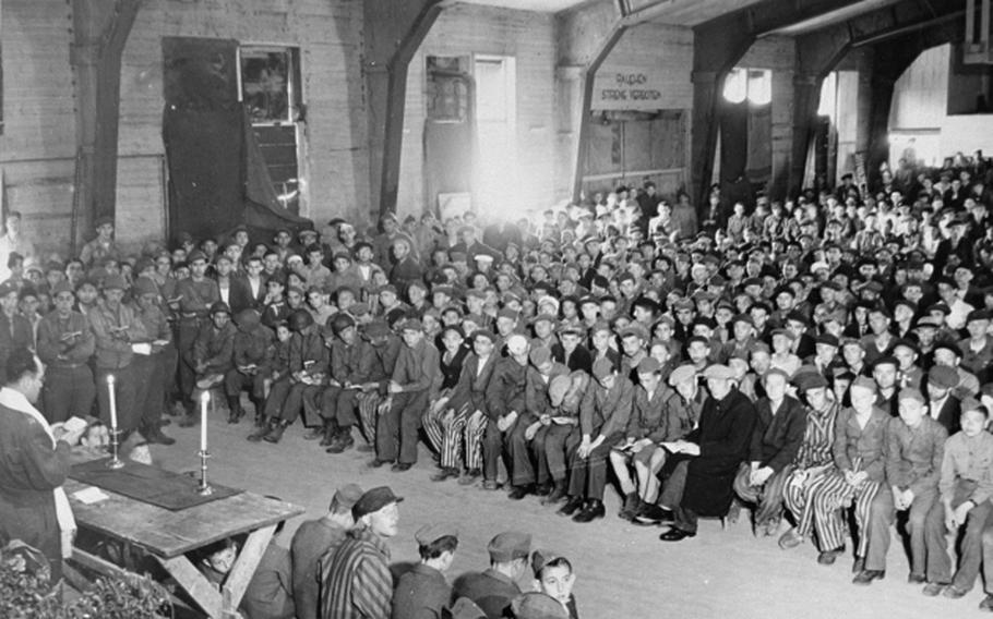 Army chaplain Rabbi Herschel Schacter conducts a Shavuoth service at Buchenwald concentration camp shortly after its liberation by the U.S. military, May 18, 1945.