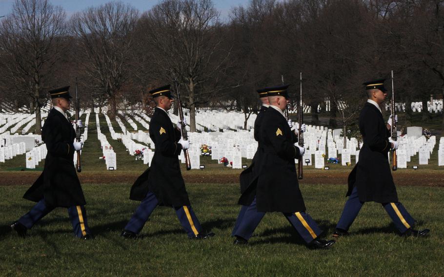 Members of the firing squad depart the burial site at the funeral of Army Capt. Andrew Pedersen-Keel at Arlington National Cemetery on March 27, 2013. Pedersen-Keel was killed March 11 in an insider attack in Afghanistan. 