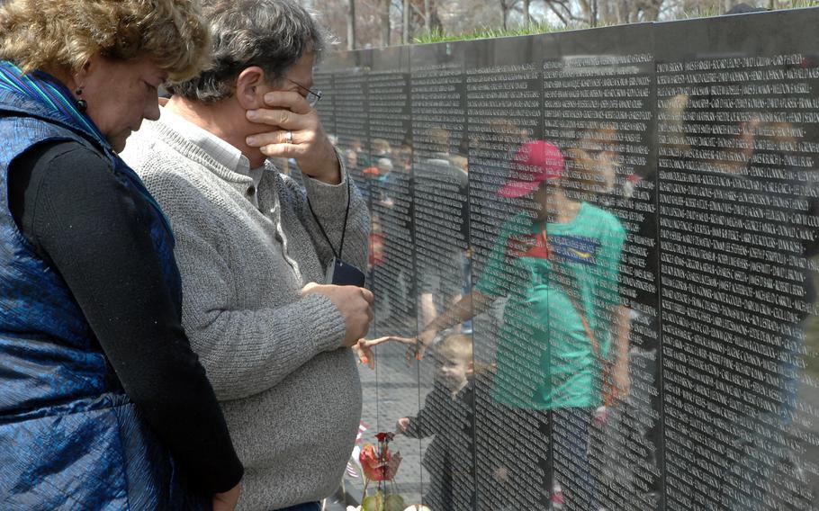 Bill Rudroff wipes away tears as he stands near the name of his best friend, Ralph Alton Branson Jr., who died in 1968. Rudroff was with his wife, Sue. At the Vietnam Veterans Memorial in Washington, D.C. on March 29, 2013, the 40th anniversary of the day the last U.S. combat troops left Vietnam. 