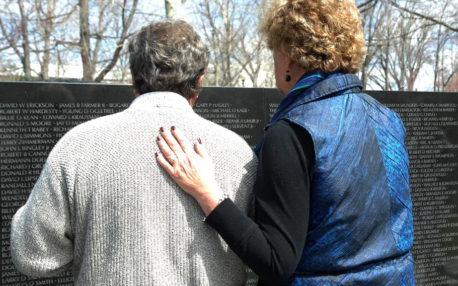 Bill Rudroff wipes away tears as he stands near the name of his best friend, Ralph Alton Branson Jr., who died in 1968. Rudroff was with his wife, Sue.  At the Vietnam Veterans Memorial in Washington, D.C. on March 29, 2013, the 40th anniversary of the day the last U.S. combat troops left Vietnam.