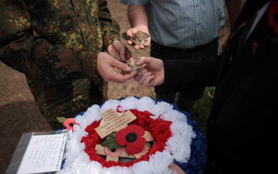 Germans in the town of Laumersheim, Germany, show fragments of the aluminum skin of the British Lancaster bomber ED 427, which went down April 17, 1943. It was long believed the ED 427 went missing over the North Sea, but crash debris and war records led researchers to conclude the plane went down in Laumersheim. On the 70th anniversary of the crash, Englishman Paul Keeley, a friend of one of the pilot's family, laid a wreath and small wooden crosses from some of the surviving families at the crash site.

