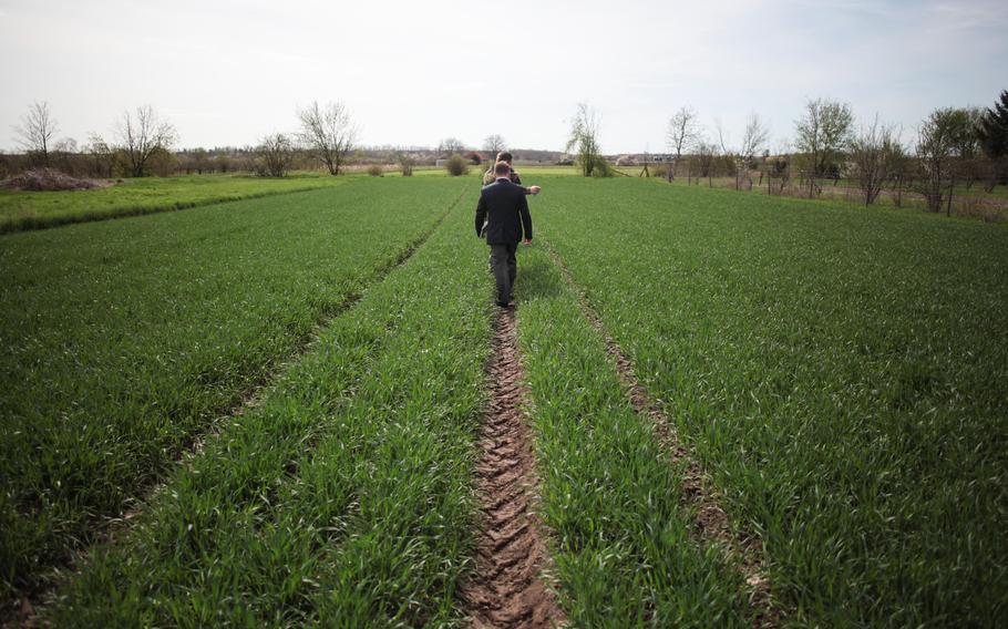 Locals escort Englishman Paul Keeley through a field where the British Lancaster bomber ED 427 crashed April 17, 1943. Keeley, a friend of the pilot's surviving family, visited the site in southwestern Germany on the 70th anniversary of the crash to lay a wreath and crosses on behalf of the dead airmen's families. 
