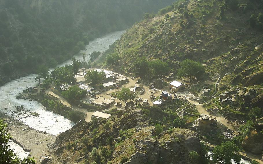 Pictured is a view of Combat Outpost Keating on the Pakistan-Afghanistan border in a remote pocket of Afghanistan, known as Nuristan. According to soldiers who called the outpost home, being at Keating was like being in a fishbowl or fighting from the bottom of a paper cup. It was there, surrounded by mountains and insurgents, that former Staff Sgt. Clinton L. Romesha and his fellow soldiers fought back the enemy in a fierce 12-hour battle, Oct. 3, 2009. 