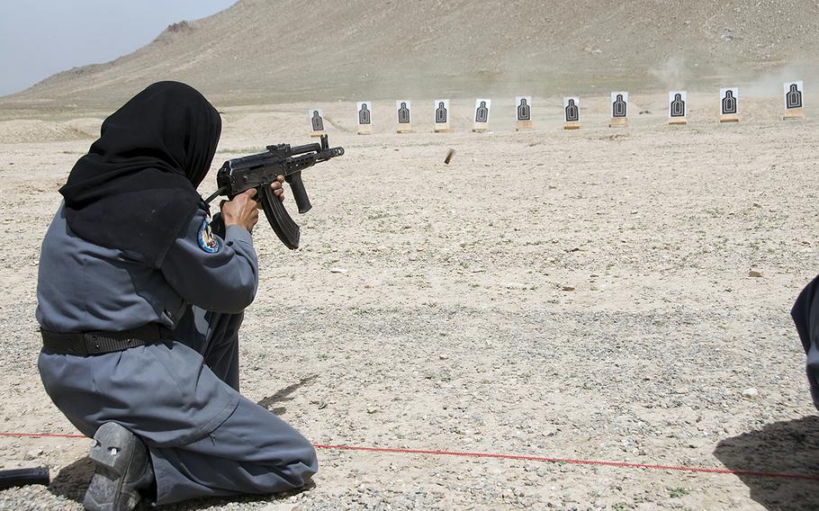 An Afghan national police woman qualifies on the AK-47 rifle during the tactical training program portion of the police basic training course at Kabul Military Training Center, April 13, 2010. 