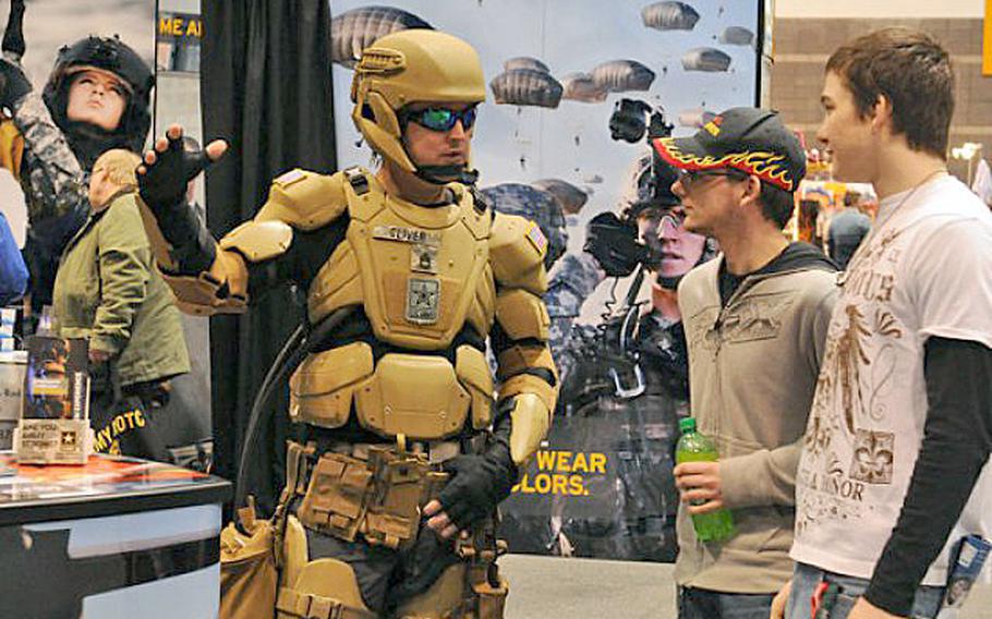 Sgt. 1st Class Matthew Oliver suits up in a futuristic combat uniform with a Tactical Assault Light Operator Suit-like look at the 2012 Chicago Auto Show.