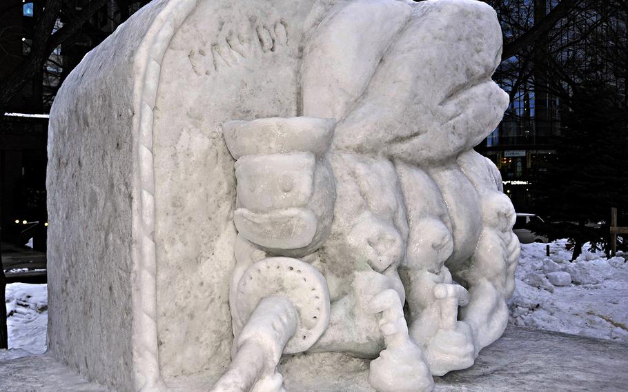 A six-foot snow sculpture depicting the U.S. Navy Seabee's "Fighting Bee" insignia is on display at the 65th Annual Sapporo Snow Festival, on Feb. 3, 2014.  