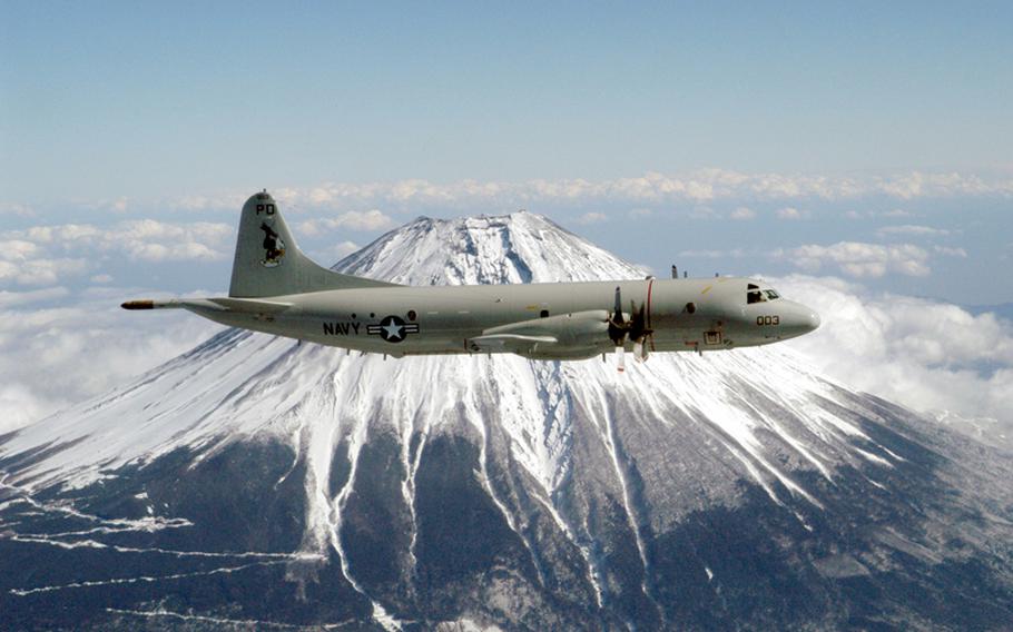 A P-3 Orion surveillance aircraft from Patrol Squadron Nine out of Kaneohe Marine Corps Base Hawaii flies by Mount Fuji Feb. 13, 2003. 