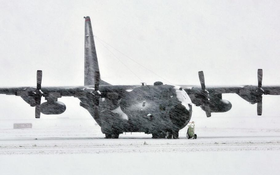 A snow-covered C-130 Hercules sits on the flight line at Yokota Air Base, Japan, during a strong snowstorm Feb. 8, 2014. About 12.7 inches of snow fell on the base, breaking the daily record for February.