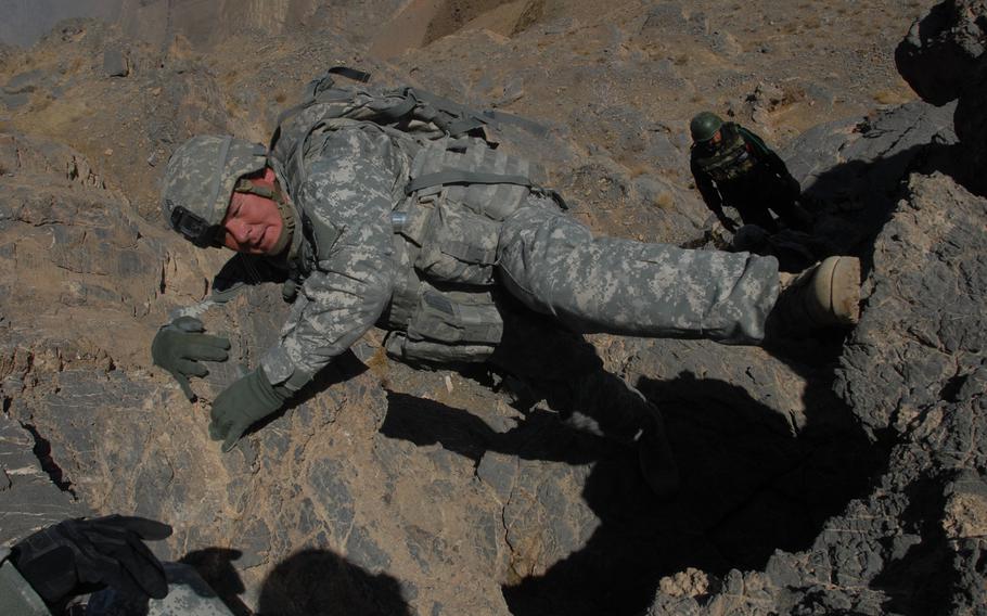 Sgt. 1st Class John Gray holds on for dear life during a mountain climb in Mizan District, Afghanistan in this 2007 file photo. For years, soldiers were given -- or purchased -- heavier climbing equipment to perform their jobs. But this week, the Army started handing out more than $11 million in new mountain-climbing gear to U.S. troops to use in places like Afghanistan. 

