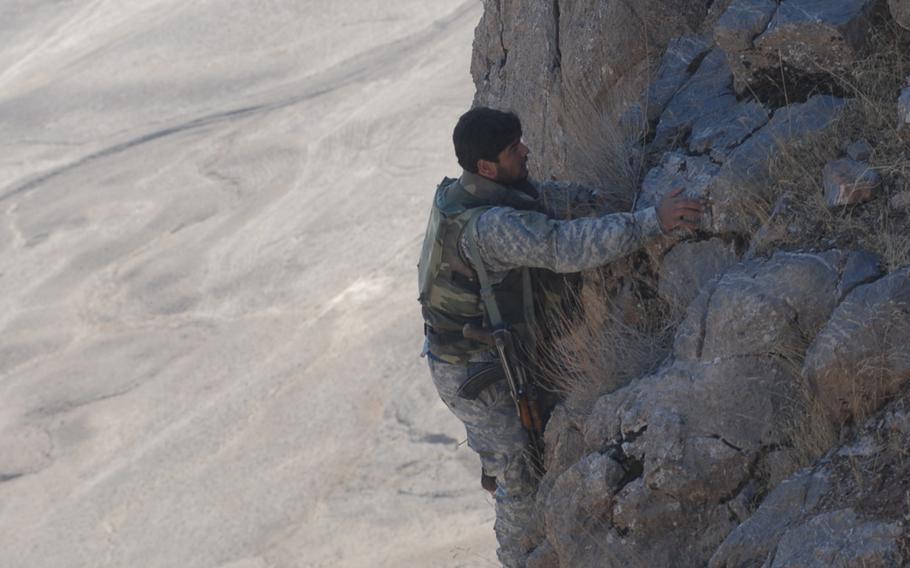 Afghan interpreter Tariq Kaihan, climbs a mountain with U.S. soldiers during a patrol in Mizan District, Afghanistan, in this 2007 file photo. For years, soldiers were given -- or purchased -- heavier climbing equipment to perform their jobs. But this week, the Army started handing out more than $11 million in new mountain-climbing gear to U.S. troops to use in places like Afghanistan. 
