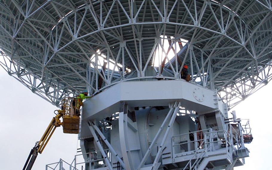 Workers lift an antenna dish onto its pedestal during construction of the Mobile User Objective System ground site in Niscemi, Sicily, in January 2014. The next-generation communication system is designed to provide secure, cellular-like voice and data signal to military networks and troops worldwide.