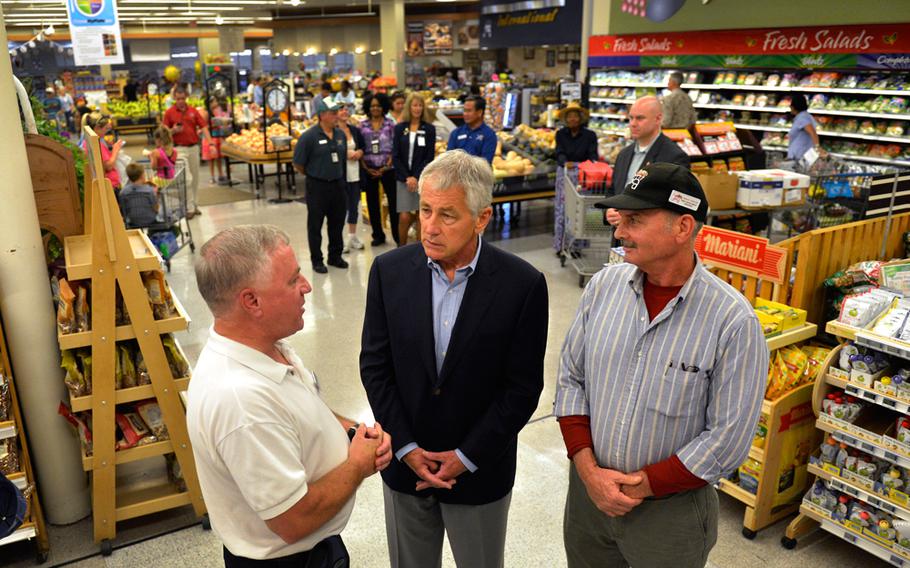 Secretary of Defense Chuck Hagel, center, tours the commissary at Naval Air Station Jacksonville, Fla., July 16, 2013.