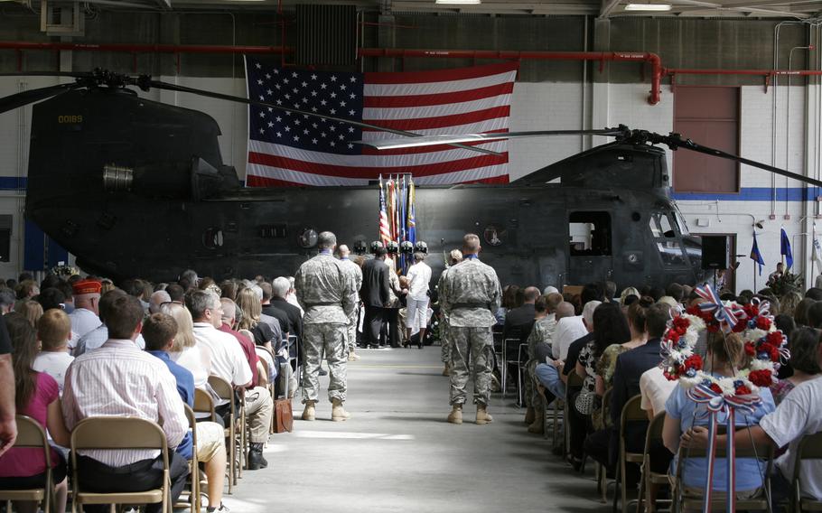 A CH-47 Chinook helicopter serves as a backdrop for a memorial service in Olathe, Kan., Aug. 14 for the air crew killed Aug. 6 when their CH-47 Chinook helicopter crashed in Afghanistan. The ceremony was attended by friends and Family members of the fallen troops as well as Patriot Guard Riders, members of a local Boy Scout troop, the Gardner, Kan. Fire Department and members of an area Veterans of Foreign Wars Post. 