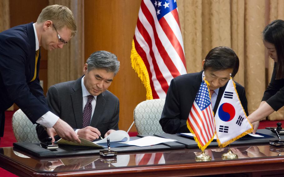 U.S. Ambassador to the Republic of Korea Sung Kim, left, and Republic of Korea Foreign Minister Yun Byung-Se signed the U.S.- ROK Special Measures Agreement Feb. 2, 2014. The agreement will be submitted to U.S. and ROK legislatures for ratification. Without the agreement, Koreans working for the U.S. military could face furloughs starting April 1.