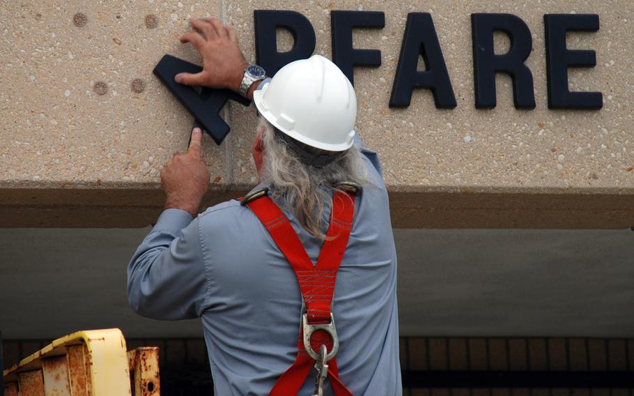Brian Brehm, facilities manager for Naval Station Ingleside, Texas, removes the letters from Mine Warfare Training Center in 2009. In its 2005 BRAC recommendation, the Defense Department recommended that the center be consolidated with Fleet Anti-submarine Warfare Training Center in San Diego, and many of its employees were moved there.