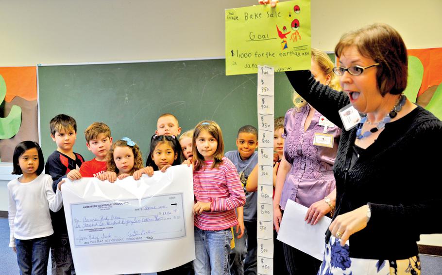 Hainerberg Elementary School Principal Penelope Miller-Smith congratulates Hainerberg second-graders for money raised during a bake sale in this April 2011 photo.