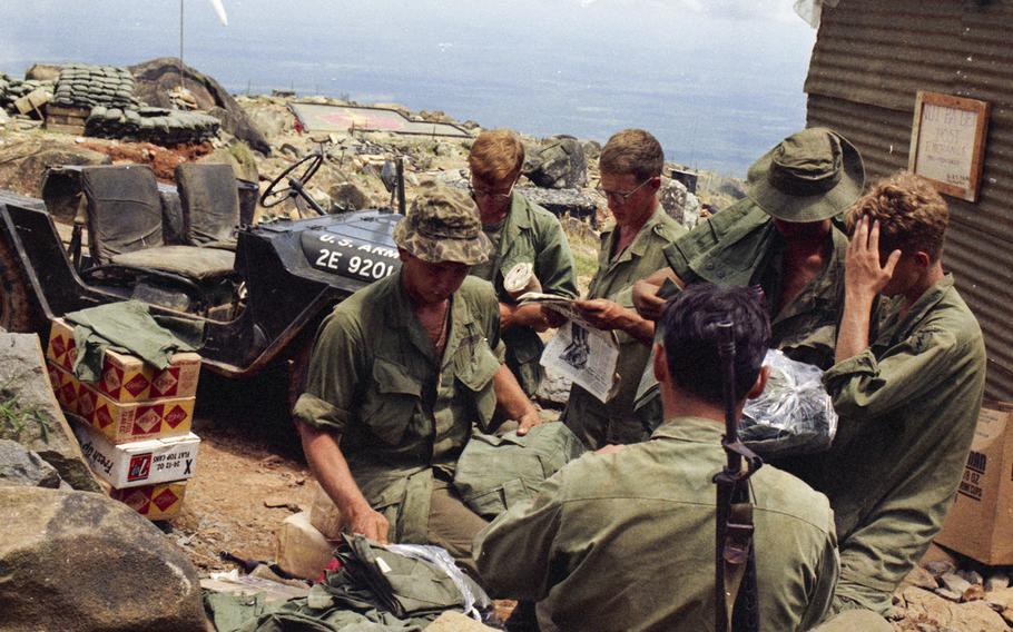 Soldiers on Nui Ba Den (Black Virgin Mountain), Vietnam, in 1969 get supplies, mail and copies of Stars and Stripes.