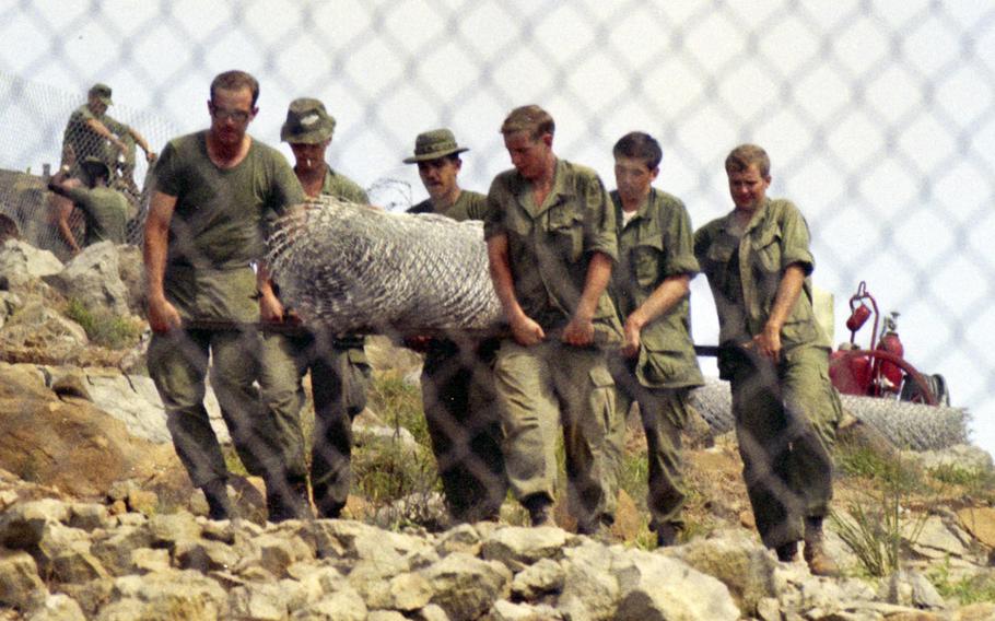 Soldiers put up a fence on Nui Ba Den (Black Virgin Mountain), Vietnam, in 1969.