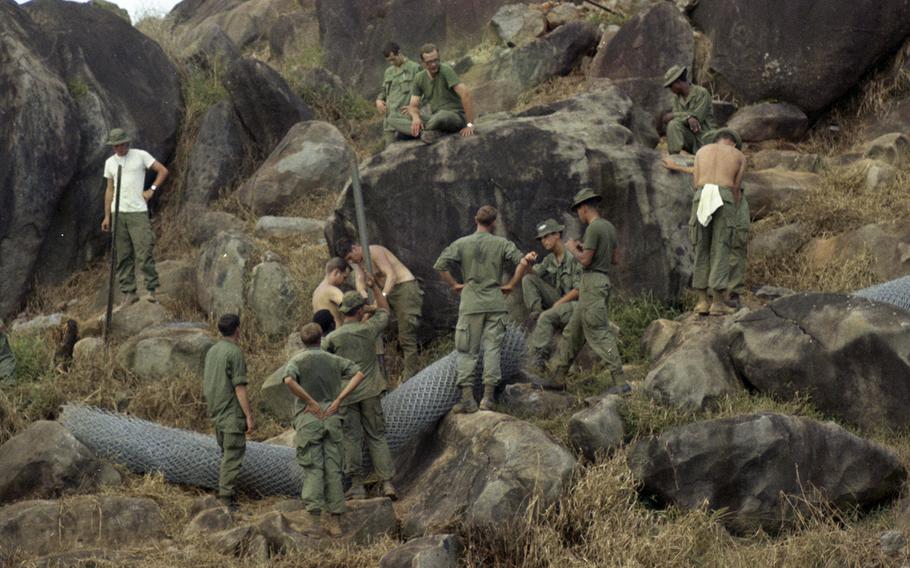 Soldiers put up a fence on Nui Ba Den (Black Virgin Mountain), Vietnam, in 1969.