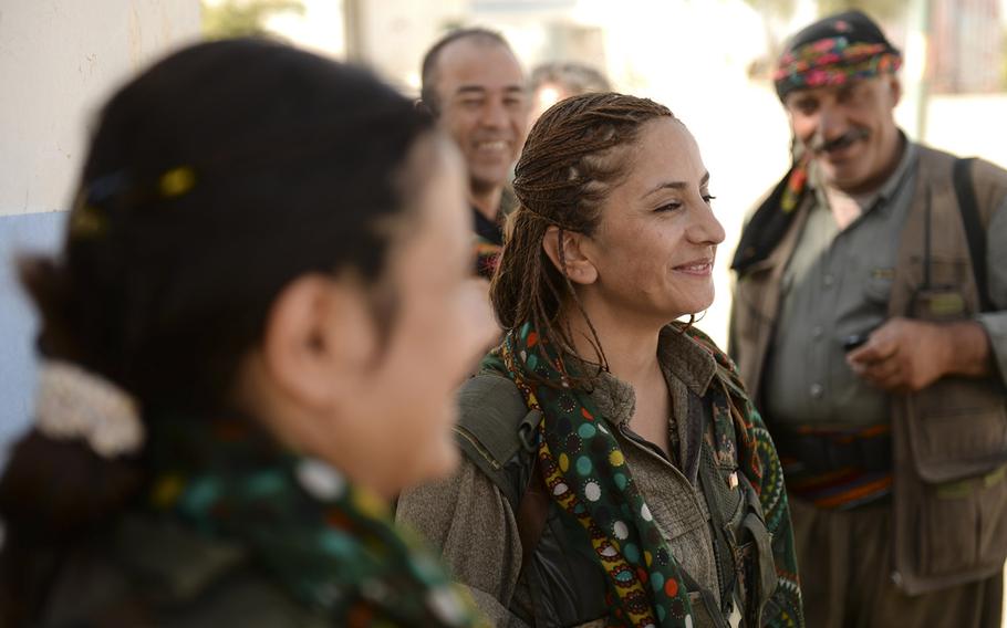 Zekia Karhan, 26, middle, and Felice Budak, 24, left, speak with a journalist in Makhmur, Iraq, on Aug. 23, 2014. Karhan and Budak are guerrillas in the Kurdistan Workers' Party.