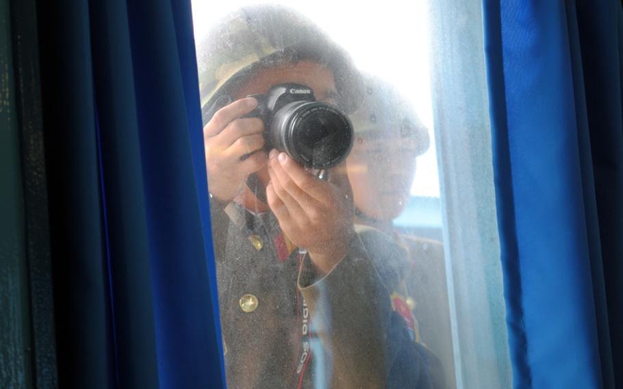 A North Korean soldier takes a photo of visiting media inside the U.N. Command Military Assistance Commission staff conference building at the Joint Security Area inside the Korean Demilitarized Zone, on Aug. 2, 2012. North Korea soldiers regularly photograph visiting members of the media.