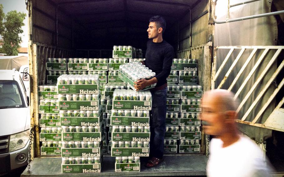 A liquor store worker unloads cases of Heineken beer in the Ankawa district of  Irbil, capital of Iraqi Kurdistan on Aug. 20, 2014.


