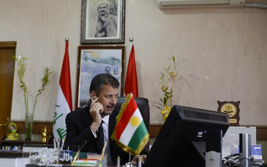 Jalal Habeeb Aziz, mayor of the Ankawa district of Irbil, in Iraqi Kurdistan, takes a phone call, Aug. 24, 2014, as he and his staff are struggling to deal with water and power shortages brought on by the influx of 40,000 displaced people into a neighborhood that was home to 35,000 Assyrian Christians.


