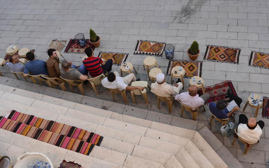 Kurdish men drink tea and visit at the base of the Irbil Citadel in the center of the capital of Iraqi Kurdistan, Aug. 25, 2014.

