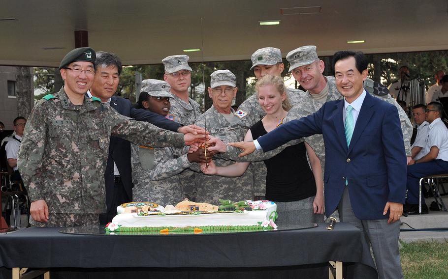 In better times, Uijeongbu Mayor Ahn Byung-yong, right, joins other South Korean dignitaries and U.S. military personnel at a cake cutting ceremony at Camp Red Cloud on June 14, 2012. The mayor boycotted a recent friendship concert at the base in protest of incidents, including an assault on a taxi driver, purportedly involving U.S. servicemembers.