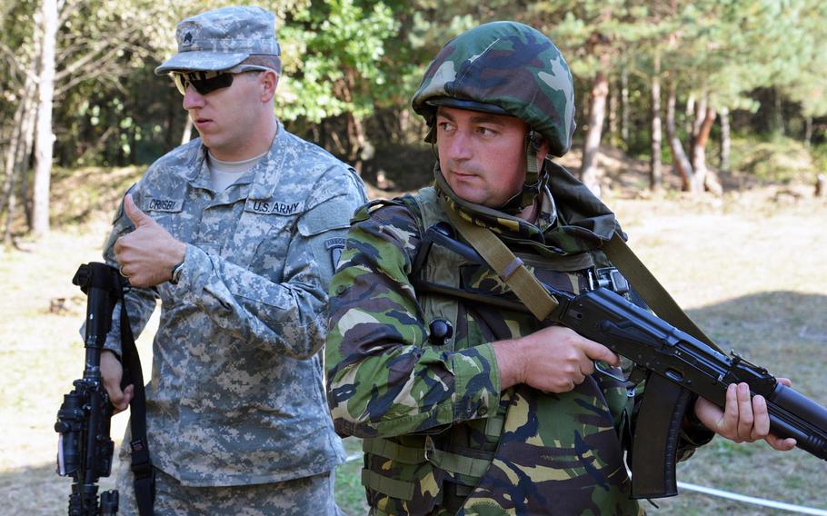 Sgt. Kevin Crosby of the 173rd Airborne Brigade gives a thumbs up after showing Romanian soldiers cordon-and-search tactics at Exercise Rapid Trident near Yavoriv, Ukraine, Thursday, Sept. 18, 2014.



