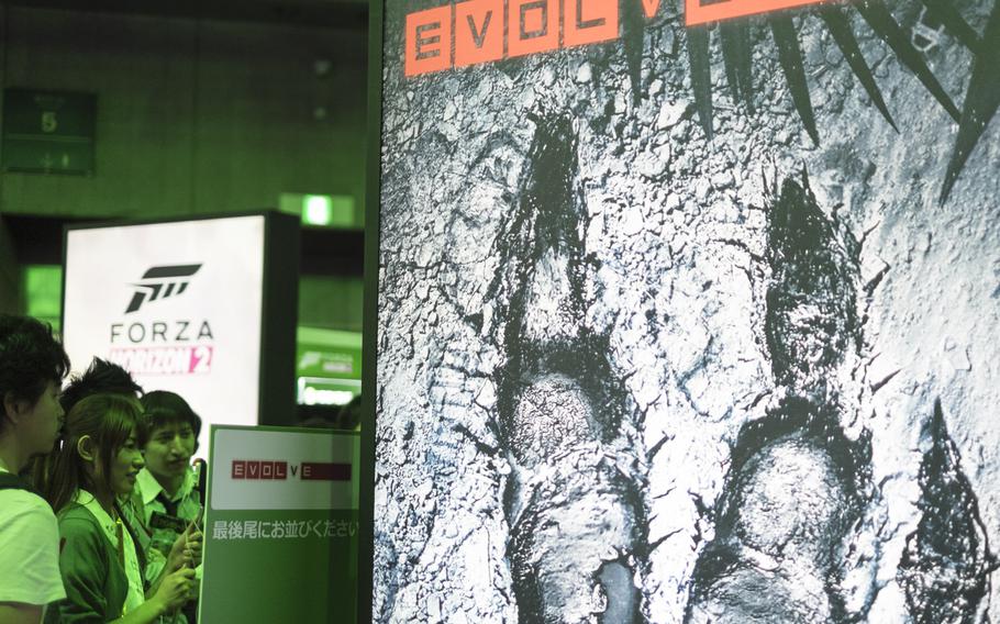 Gamers get a sneak peak at ''Evolve'' for XBox One at the Tokyo Game Show Sept. 18, 2014, in Makuhari, Japan. The first-person shooter is due out in February.