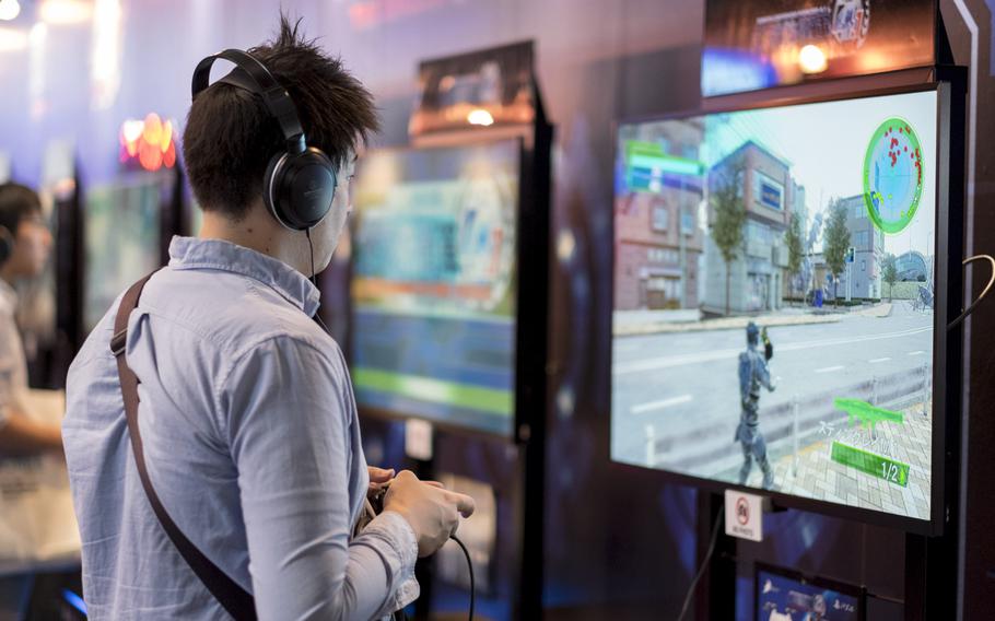 A gamer tests out a pre-release from the ''Earth Defense Force'' series at the D3 Publisher booth at the Tokyo Game Show Sept. 18, 2014, in Maruhaki, Japan.