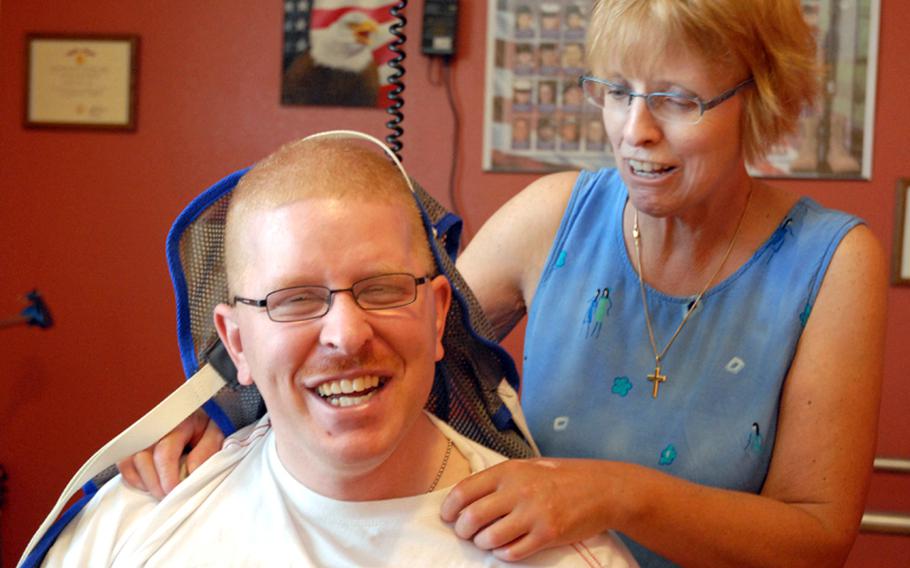 Christine Schei with her son, Erik, during one of his therapy sessions. Army Spc. Erik Schei was shot in the head during a patrol in Iraq on Oct. 26, 2005. In a report published Thursday, Sept. 19, 2014, the Government Accountability Office said the Department of Veterans Affairs significantly underestimated demand for a caregiver program for Iraq and Afghanistan war veterans.