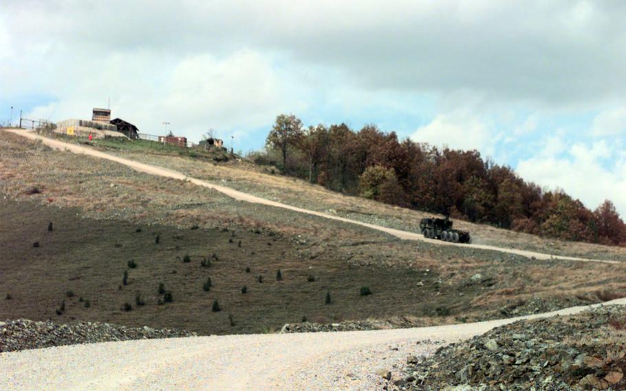An SFOR vehicle makes its way up the steep path to the top of Mount Vis in 1998.
