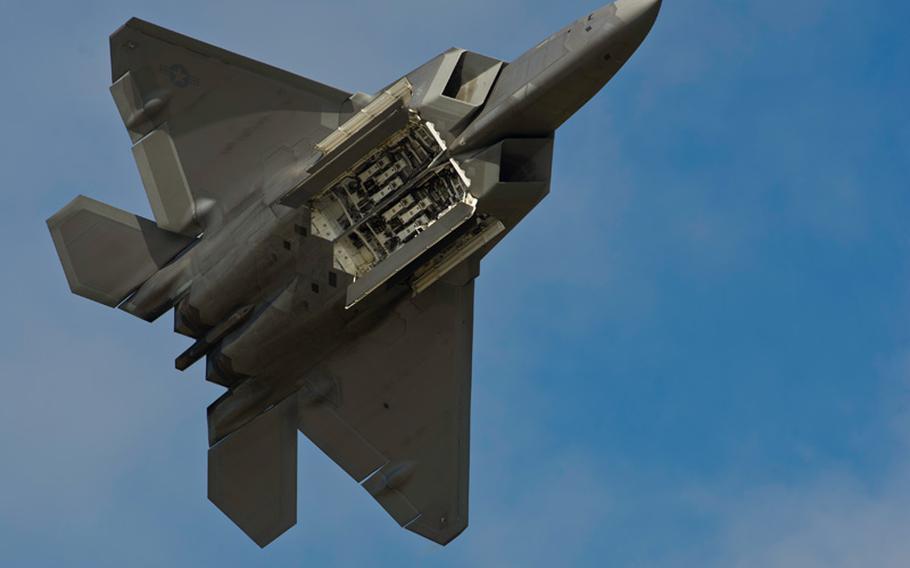 An F-22 Raptor displays its weapons bays to the crowd July 26, 2014, during the Arctic Thunder Open House at Joint Base Elmendorf-Richardson, Alaska. On Tuesday, Sept. 23, 2014, Pentagon officials said Raptors were among the aircraft that flew missions over Syria providing airstrikes against Islamic State militants.