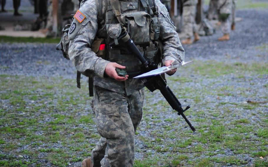 U.S. Army Sgt. Nicholis Couture, assigned to 4th Battalion, 319th Airborne Field Artillery Regiment, 173rd Airborne Brigade,  navigates through a land navigation course, part of the European Best Warrior Competition in Grafenwoehr, Germany, Sept. 14, 2014. Couture came away with the 2014 USAREUR NCO of the year. 