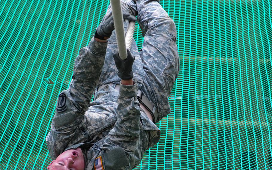 U.S. Army Pfc. Nicholas Hanson, assigned to 4th Battalion, 319th Airborne Field Artillery Regiment, 173rd Airborne Brigade, negotiates the inverted rope climb obstacle during the European Best Warrior Competition in Grafenwoehr, Germany, Sept. 14, 2014. Hanson was named the 2014 USAREUR Soldier of the Year.