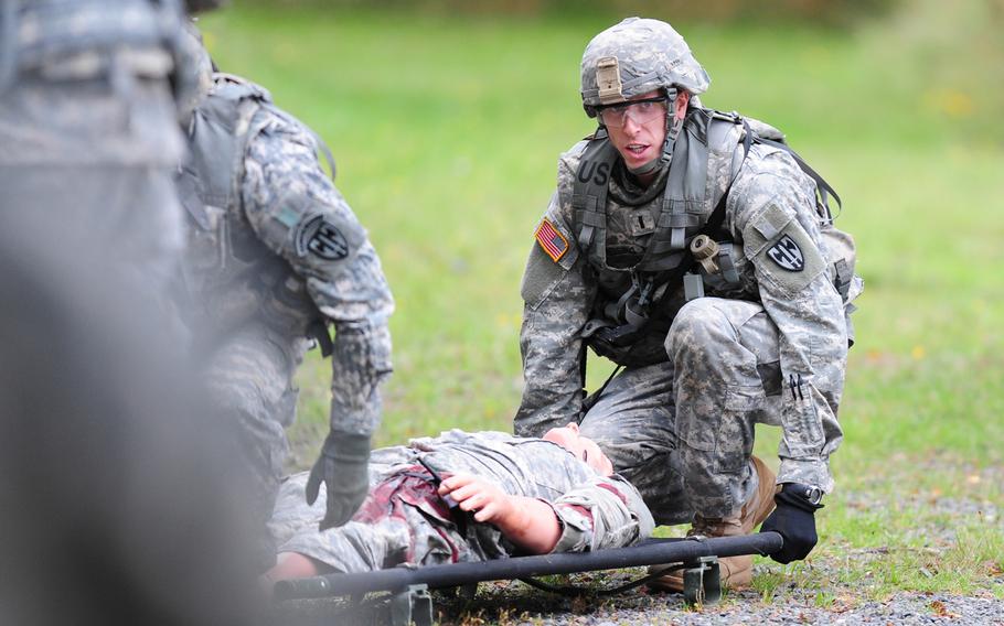 U.S. Army 1st Lt. Michael Theising, 15th Engineer Battalion, 21st Theater Sustainment Command, prepares to move a simulated casualty during the live fire lane of the European Best Warrior Competition in Grafenwoehr, Germany, Sept. 15, 2014. Theising earned the 2014 USAREUR Best Junior Officer award.