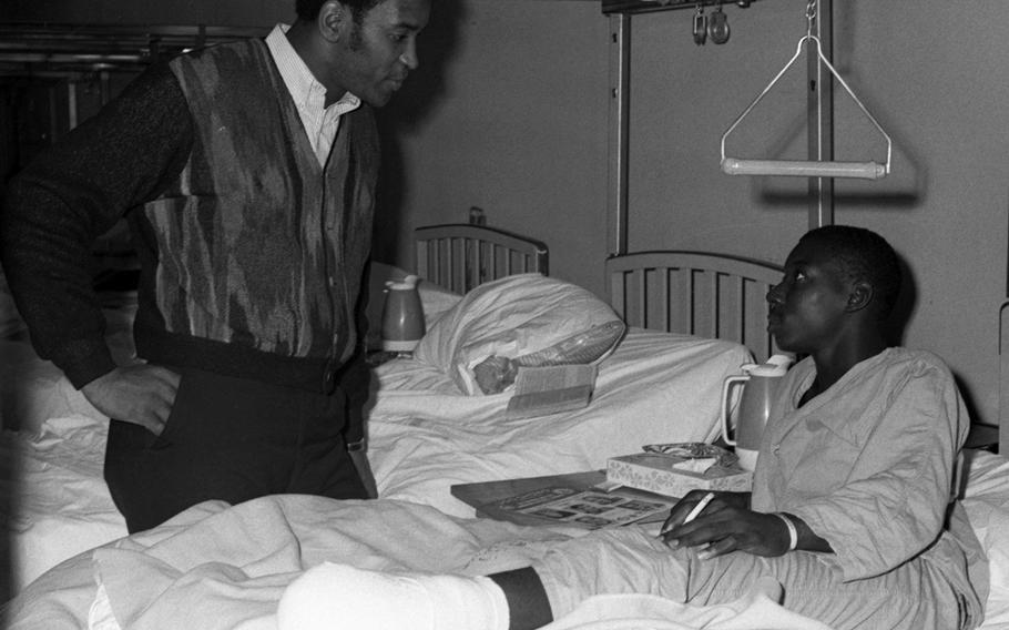 Marv Fleming talks with a servicemember at the U.S. Army Hospital on Camp Oji, Japan, in January, 1969.