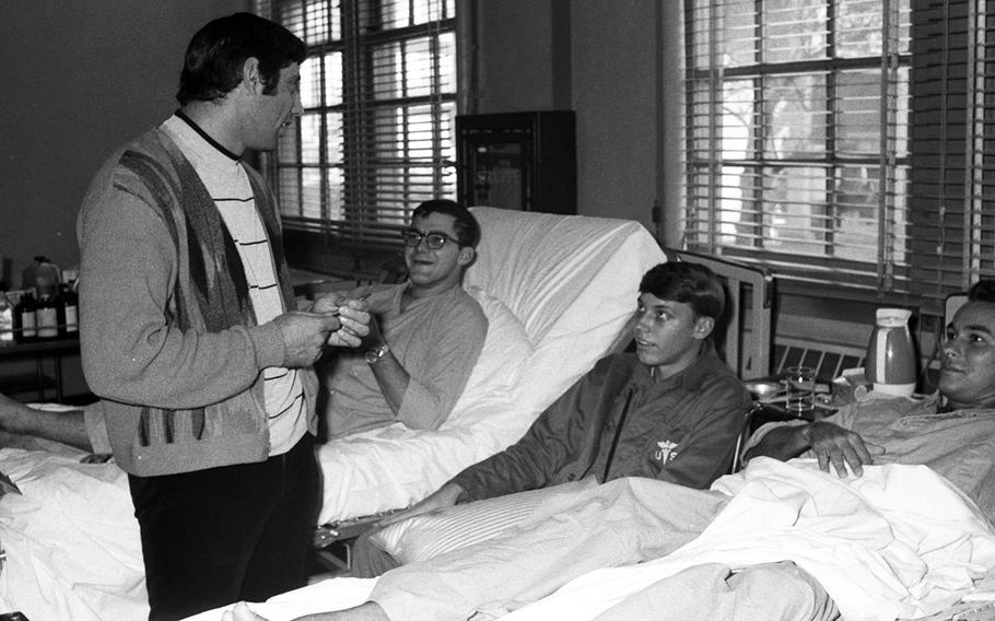 Joe Namath talks with patients at the U.S. Army Hospital on Camp Oji, Japan, in January, 1969.