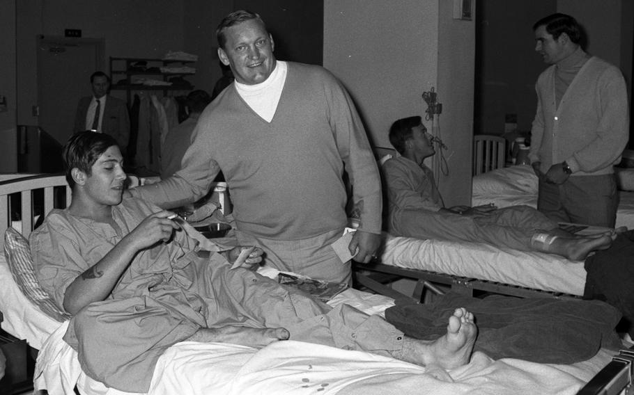 Jim Otto of hte Oakland Raideers talks to a patient at the U.S. Army Hospital on Camp Oji, Japan, in January, 1969.