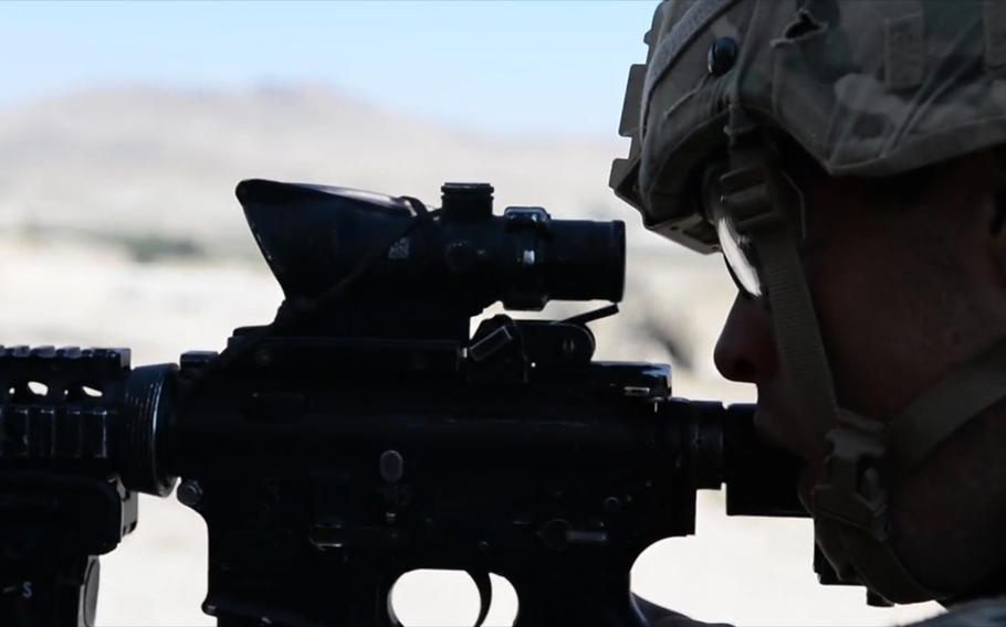 A video screen grab shows a Dragon Troop soldier taking aim while deployed to Logar province, Afghanistan, in September 2014.