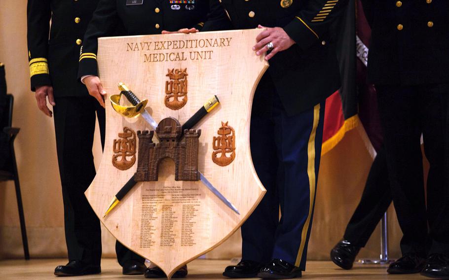 Landstuhl Regional Medical Center's command group stands with a gift presented them Friday, Sept. 26, 2014, by the senior enlisted members of all of the iterations of the Navy Expeditionary Medical Unit who have served at the hospital since 2006.