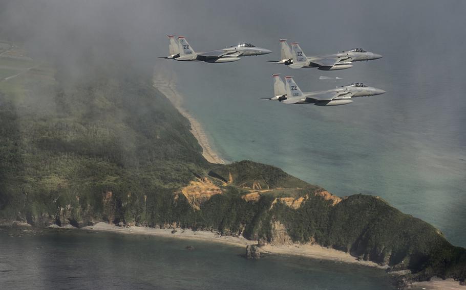 U.S. Air Force F-15 Eagles from the 67th Fighter Squadron fly a training mission over the Pacific Ocean outside of Kadena Air Base, Japan, Aug. 25, 2014.